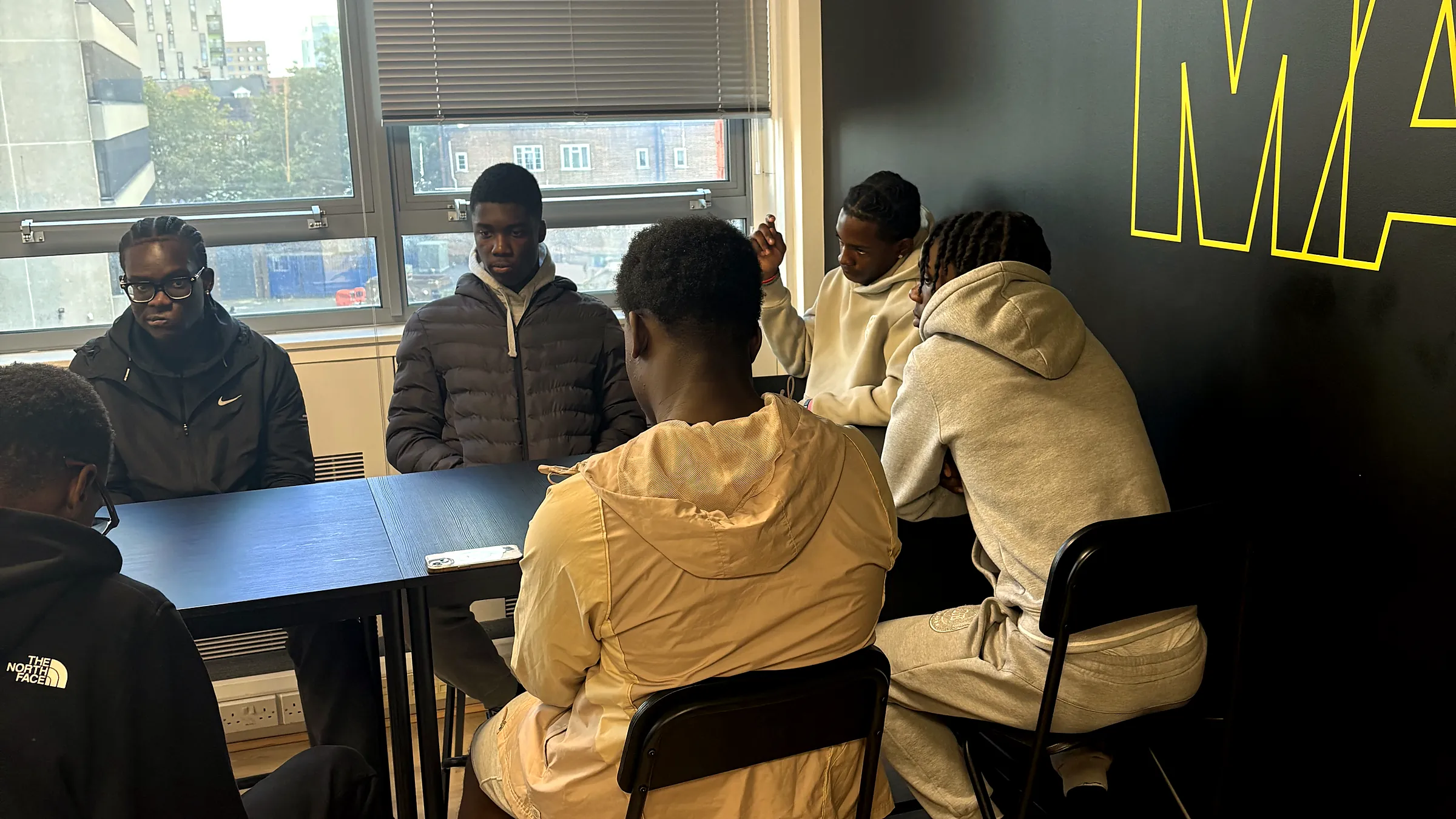 Young people sitting round a table together at a JDS session at Make It Barking