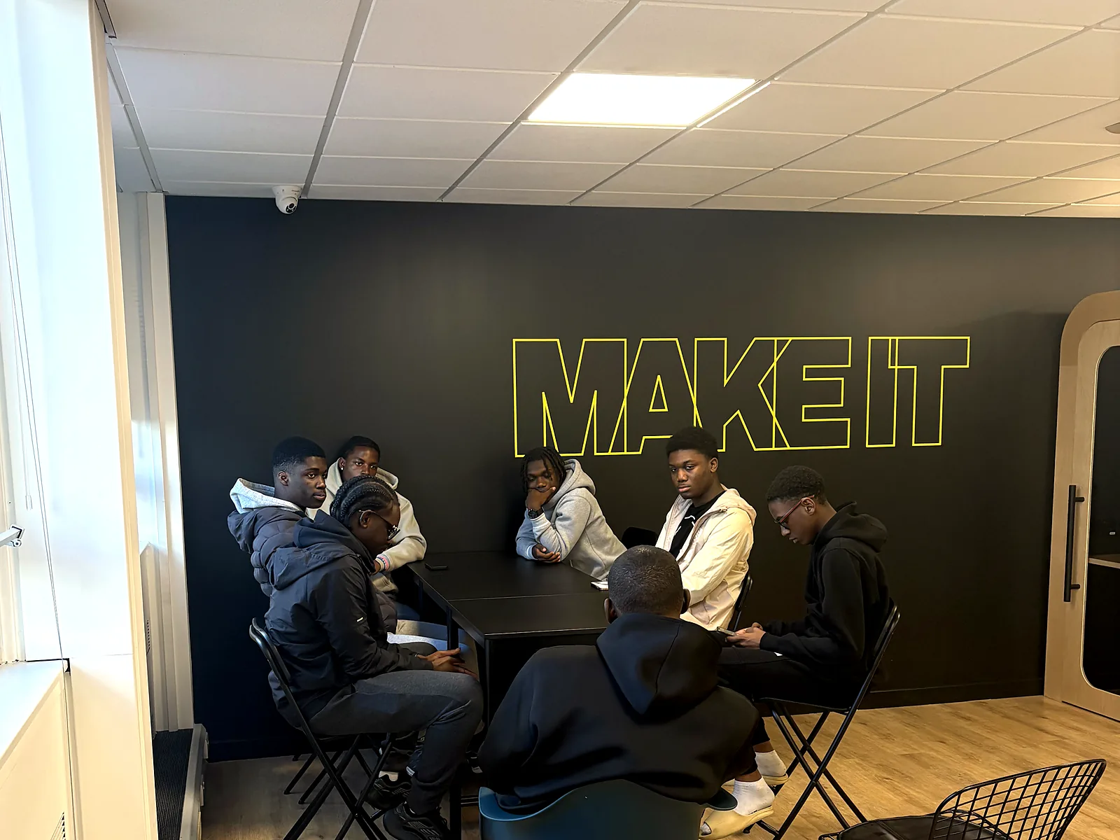 A group meeting around a table in the Make It Barking lounge